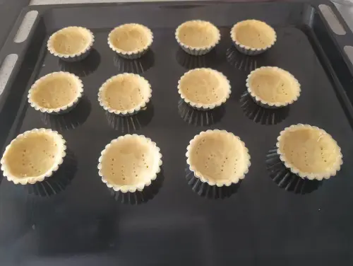 After baking the tart shells, cool them on a rack before filling.